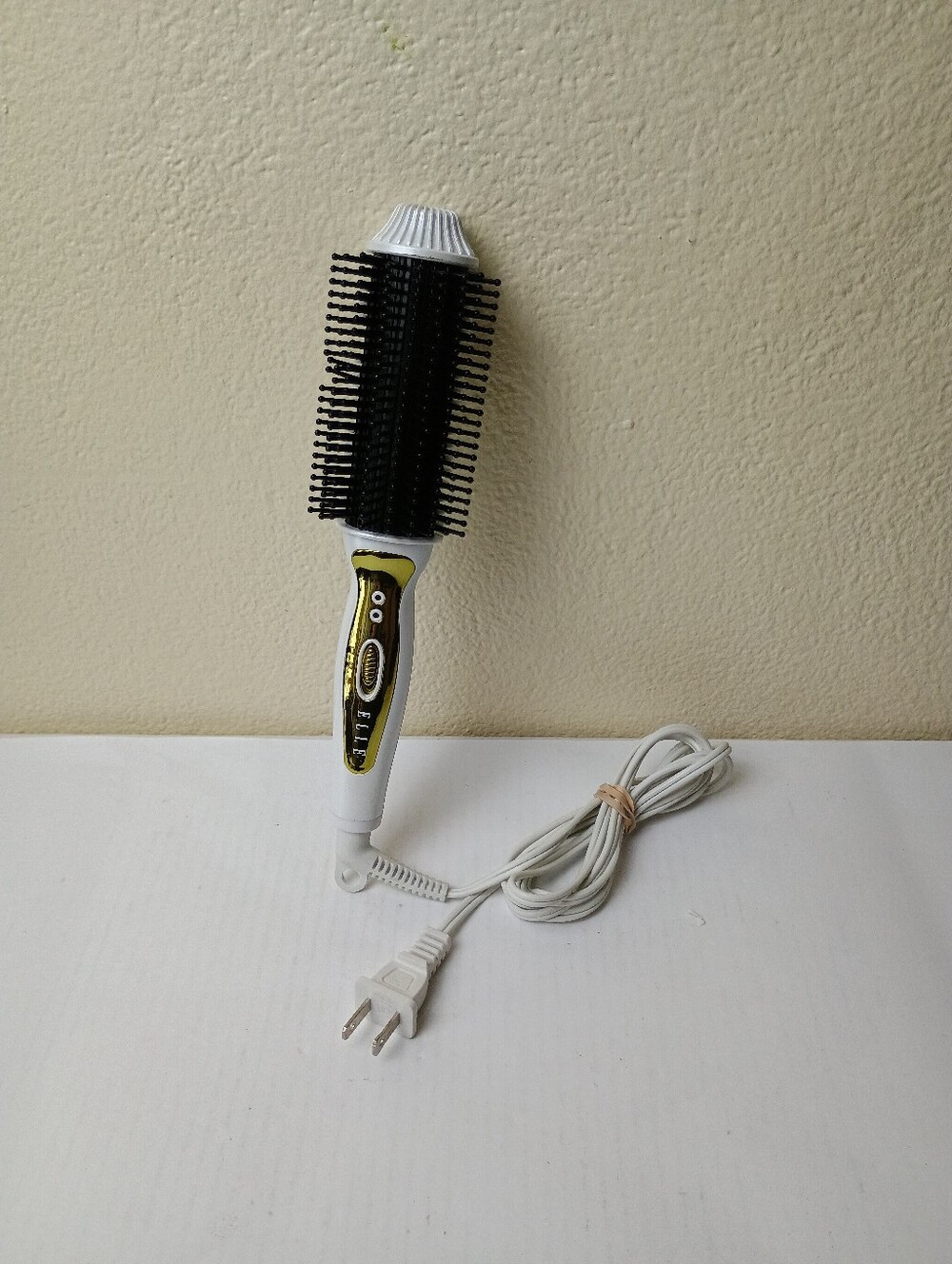 Elle White and Black Heated Volumizing Brush Curls, Waves, And Straightens Hair